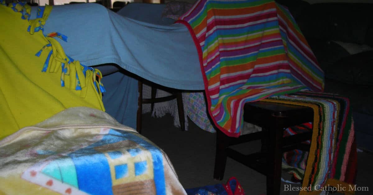 Image of a fort made with chairs and blankets.