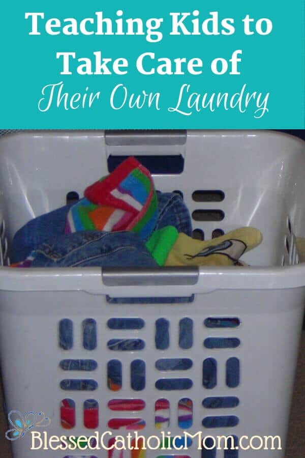 Here is a simple solution to our family's laundry dilemma: kids can do their own laundry. When we work as a family, we share the work load. Image of a white basket full of laundry. Title of article and Blessed Catholic Mom logo on image. 