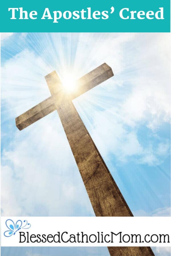 Image of a cross with the sun shining behind it in a blue sky with some white clouds.