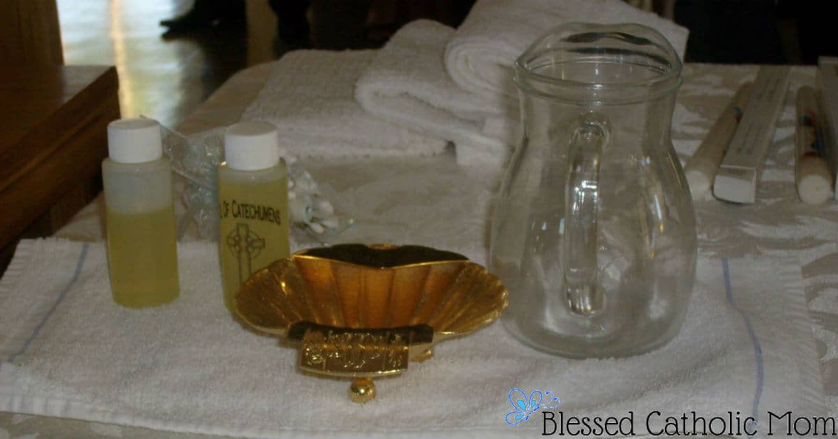Just as we celebrate our birthdays, it is nice to celebrate the day we became a member of the family of God through our baptism. Image of chrism oil, a golden shell, candles, and a water pitcher. #baptism