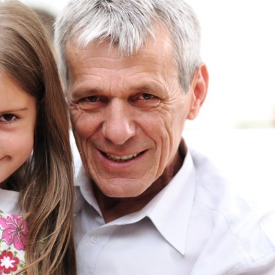 Image of a grandfather holding his young granddaughter.