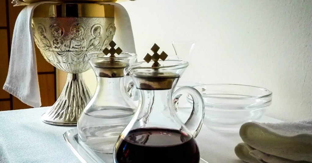 Image of a Chalice and two vessels holing water and wine to be ready for consecration before Holy Communion.