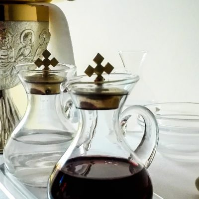 Image of a Chalice and two vessels holing water and wine to be ready for consecration before Holy Communion.
