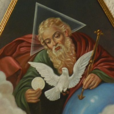 Image of the Blessed Trinity: God he Father holding the Eucharist (Jesus) with a white dove (the Holy Spirit) in front of them. A triangle is behind the head of God the Father.