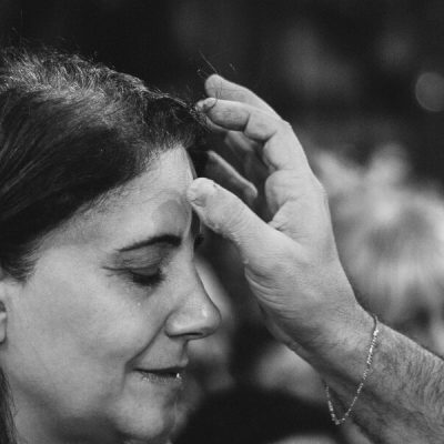 Image of a woman receiving ashes on her forehead on Ash Wednesday.