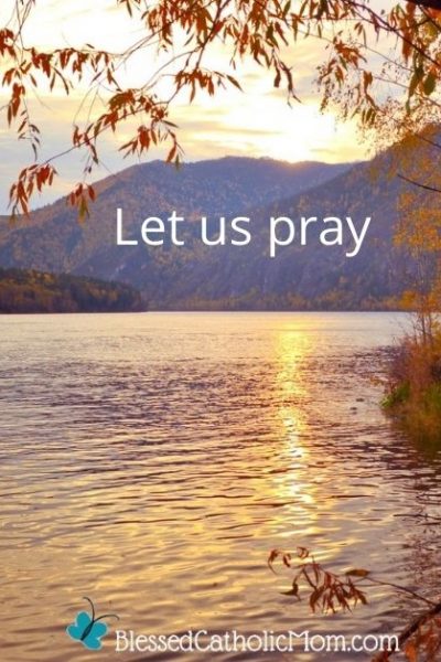 Image of the sun shine on a lake with mountains in the background and part of a fall tree in the foreground on the right side. The words Let us Pray are imposed over the mountains and the logo for Blessed Catholic Mom is at the bottom of the image.