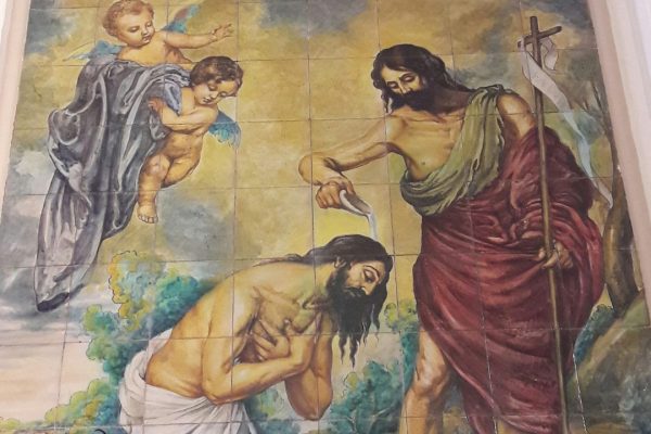 Image of a tiled painting of St. John the Baptist baptizing Jesus in the river with angels watching. Words above the image read: Litany for St. John the Baptist. The logo for Blessed Catholic Mom is at the bottom.