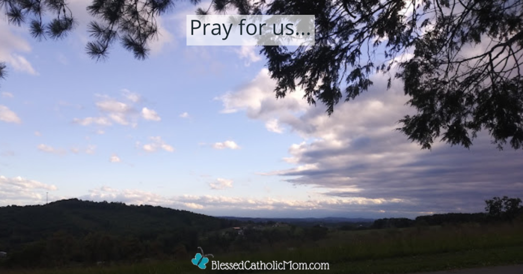 Image of a tree with hills and skyline in the background. Words at the top of the image read Pray for us... Logo for Blessed Catholic Mom at the bottom of the image.